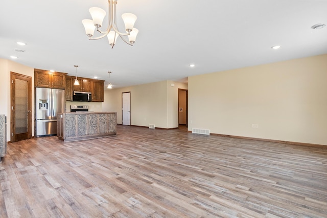 607 Colfax St, Parkers Prairie, MN 56361 - kitchen with appliances with stainless steel finishes, open floor plan, light wood-style flooring, recessed lighting, and a kitchen island