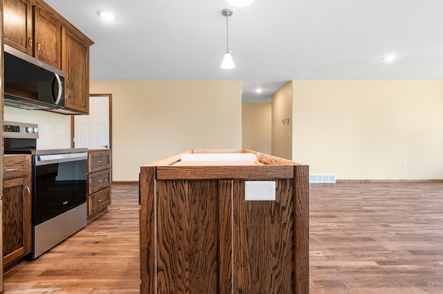 607 Colfax St, Parkers Prairie, MN 56361 - kitchen with stainless steel appliances, light wood finished floors, pendant lighting, and recessed lighting