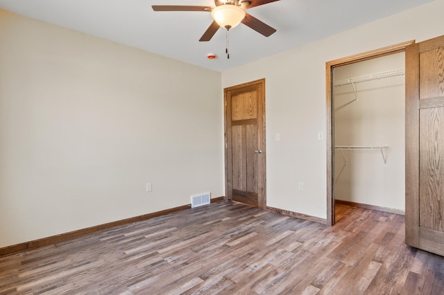 607 Colfax St, Parkers Prairie, MN 56361 - unfurnished bedroom with wood finished floors, a closet, a spacious closet, and ceiling fan
