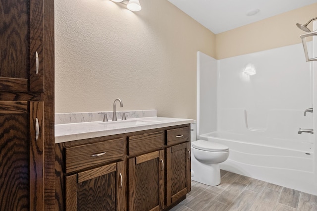 607 Colfax St, Parkers Prairie, MN 56361 - bathroom featuring vanity, a textured wall, bathtub / shower combination, and wood finished floors