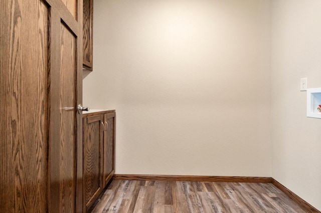 607 Colfax St, Parkers Prairie, MN 56361 - laundry area featuring cabinet space, washer hookup, and wood finished floors