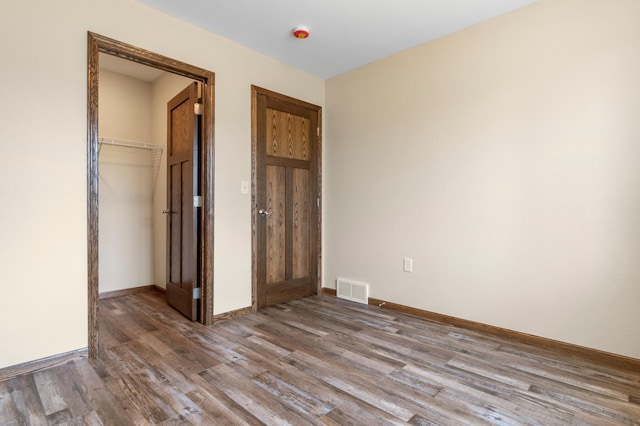 607 Colfax St, Parkers Prairie, MN 56361 - unfurnished bedroom with wood finished floors and a closet