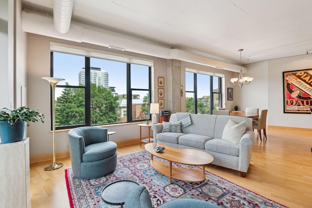 150 2nd St NE Unit B302, Minneapolis, MN 55413 - living room featuring a chandelier and wood finished floors