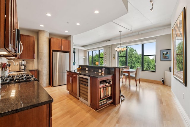 150 2nd St NE Unit B302, Minneapolis, MN 55413 - kitchen with wine cooler, appliances with stainless steel finishes, light wood-style floors, a chandelier, and recessed lighting