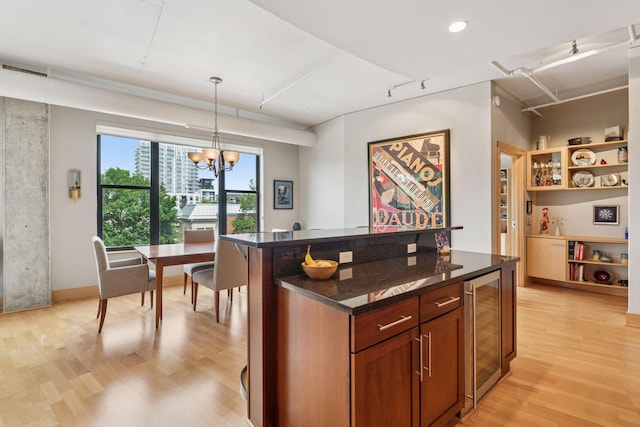 150 2nd St NE Unit B302, Minneapolis, MN 55413 - kitchen with wine cooler, light wood-type flooring, a chandelier, decorative light fixtures, and dark stone countertops