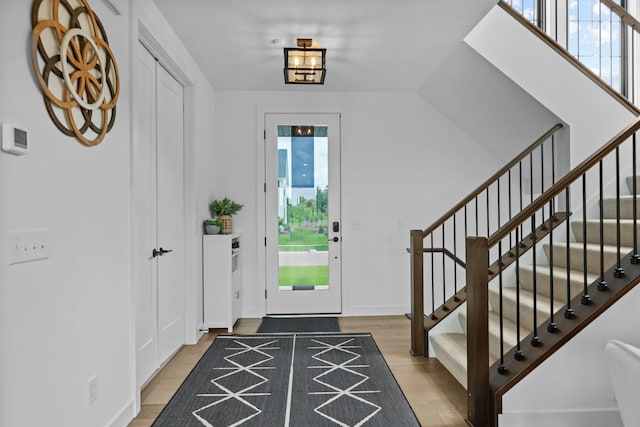 9612 Iron Horse Rd, Woodbury, MN 55129 - entryway featuring healthy amount of natural light, stairs, and wood finished floors