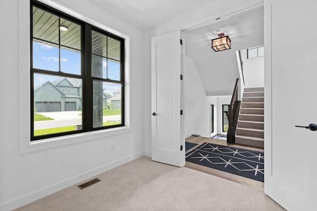 9612 Iron Horse Rd, Woodbury, MN 55129 - carpeted foyer entrance featuring stairs and baseboards