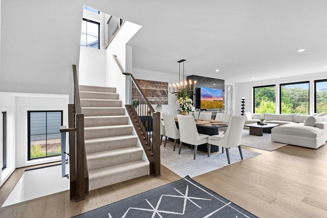 9612 Iron Horse Rd, Woodbury, MN 55129 - surrounding community with an outdoor living space with a fire pit, a chandelier, stairs, and recessed lighting
