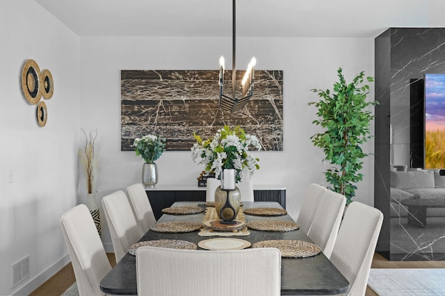 9612 Iron Horse Rd, Woodbury, MN 55129 - dining space with wood finished floors and a chandelier
