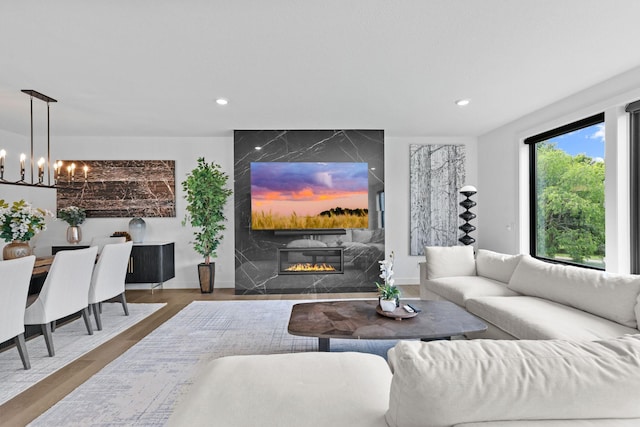 9612 Iron Horse Rd, Woodbury, MN 55129 - living area featuring a chandelier, recessed lighting, a fireplace, and wood finished floors