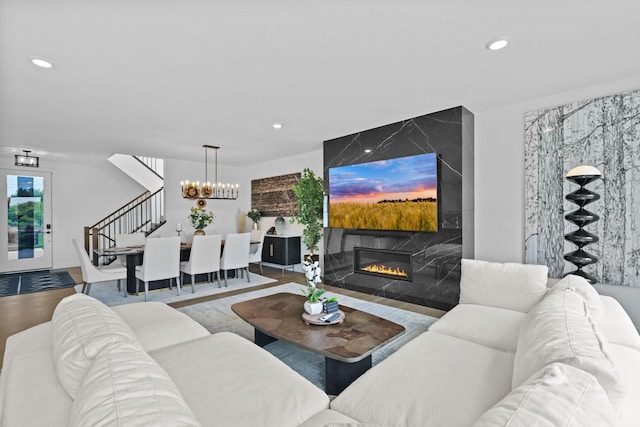 9612 Iron Horse Rd, Woodbury, MN 55129 - living area featuring stairs, recessed lighting, a high end fireplace, a chandelier, and an accent wall