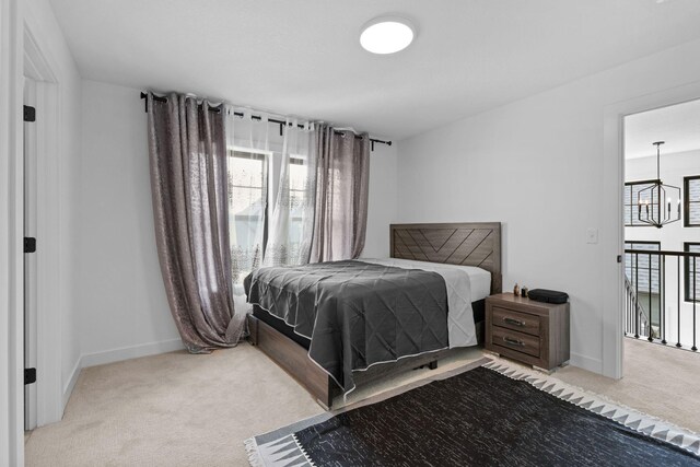 9612 Iron Horse Rd, Woodbury, MN 55129 - carpeted bedroom with baseboards and a chandelier