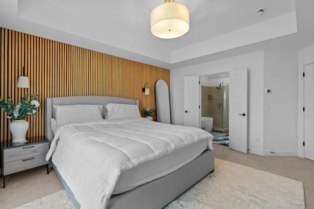 9612 Iron Horse Rd, Woodbury, MN 55129 - bedroom with a raised ceiling, light carpet, and ensuite bath