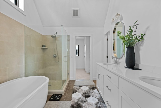 9612 Iron Horse Rd, Woodbury, MN 55129 - bathroom with a shower stall, a soaking tub, double vanity, and tile patterned flooring