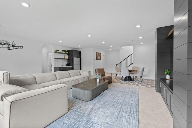 9612 Iron Horse Rd, Woodbury, MN 55129 - living room with recessed lighting, arched walkways, light carpet, and stairway