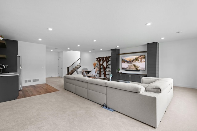 9612 Iron Horse Rd, Woodbury, MN 55129 - living area featuring light colored carpet, recessed lighting, and stairs
