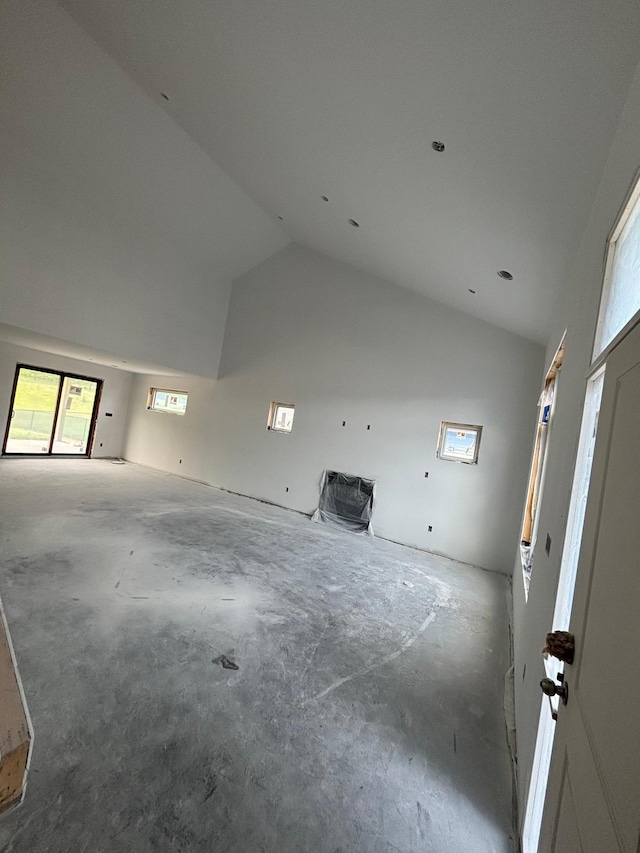 3641 18th St SE, Rochester, MN 55904 - unfurnished living room featuring vaulted ceiling, concrete floors, and healthy amount of natural light