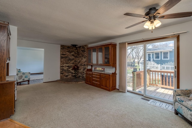 301 Nottingham Ct, North Mankato, MN 56003 - living area with a textured ceiling, light colored carpet, and ceiling fan