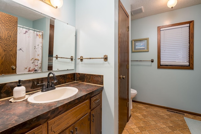 301 Nottingham Ct, North Mankato, MN 56003 - full bath featuring vanity, a textured ceiling, and tile patterned floors