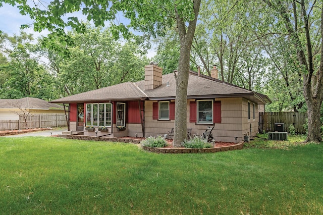 11542 Xavis St NW, Coon Rapids, MN 55433 - view of front of house featuring a chimney, roof with shingles, a patio, and a fenced backyard