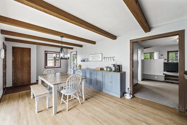 11542 Xavis St NW, Coon Rapids, MN 55433 - dining room featuring light wood finished floors, a chandelier, and beam ceiling