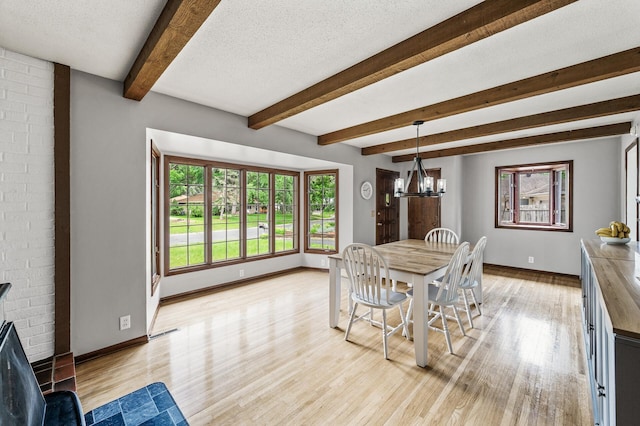 11542 Xavis St NW, Coon Rapids, MN 55433 - dining room with light wood-type flooring, beamed ceiling, a chandelier, and a textured ceiling