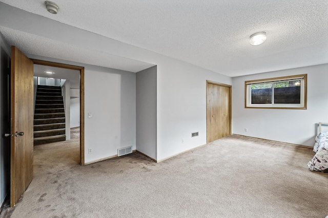 11542 Xavis St NW, Coon Rapids, MN 55433 - carpeted spare room with a textured ceiling, stairway, and a smoke detector