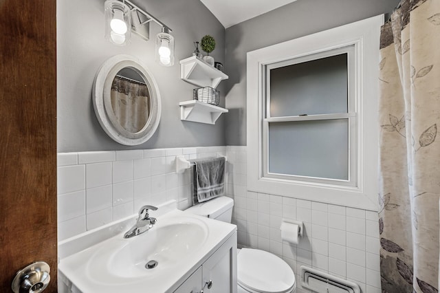 11542 Xavis St NW, Coon Rapids, MN 55433 - bathroom featuring tile walls, vanity, a wainscoted wall, and a shower with shower curtain