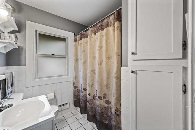 11542 Xavis St NW, Coon Rapids, MN 55433 - full bath with tile walls, tile patterned floors, curtained shower, and a wainscoted wall