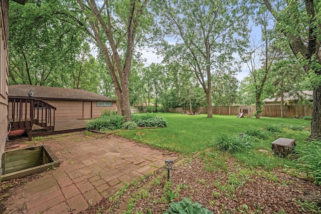 11542 Xavis St NW, Coon Rapids, MN 55433 - fenced backyard with a wooden deck, a patio, and a playground