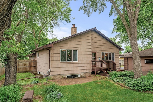 11542 Xavis St NW, Coon Rapids, MN 55433 - rear view of property with a wooden deck and a chimney
