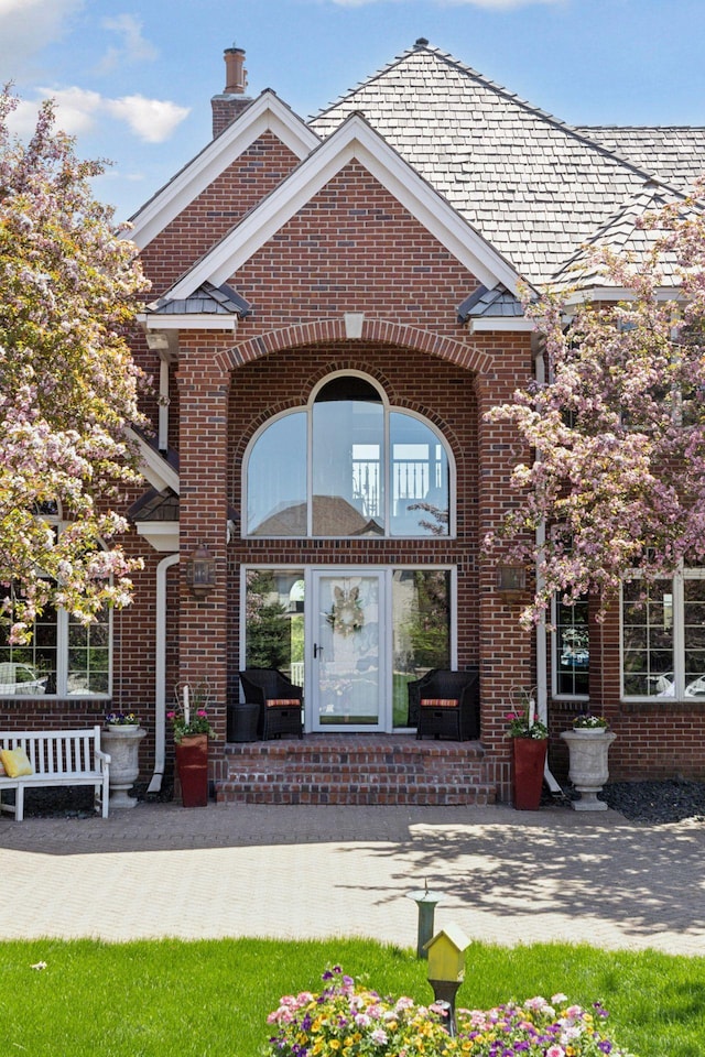 10 Apple Orchard Ct, Dellwood, MN 55110 - view of exterior entry with brick siding and a chimney
