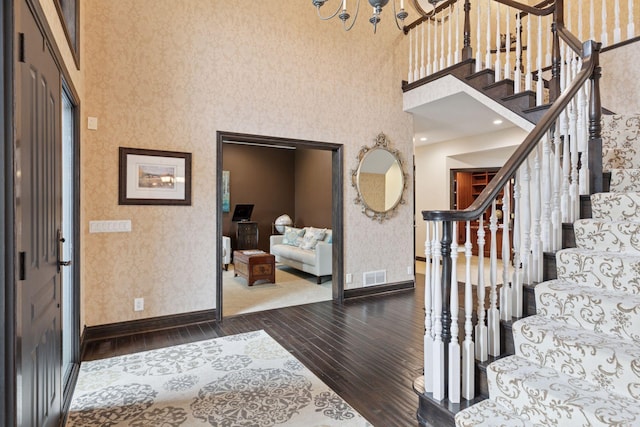 10 Apple Orchard Ct, Dellwood, MN 55110 - foyer with wallpapered walls, hardwood / wood-style floors, a high ceiling, stairway, and a chandelier