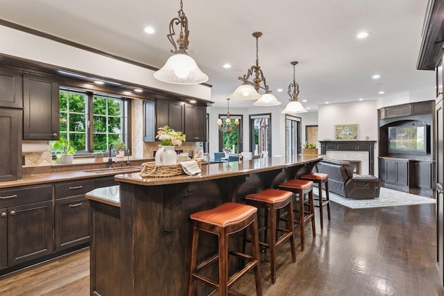 10 Apple Orchard Ct, Dellwood, MN 55110 - kitchen featuring a center island, dark wood finished floors, recessed lighting, dark brown cabinets, and open floor plan