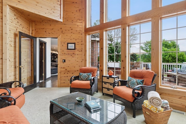 10 Apple Orchard Ct, Dellwood, MN 55110 - living area with wood walls, healthy amount of natural light, a towering ceiling, and wood finished floors