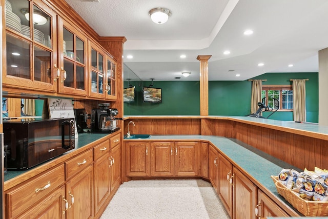 10 Apple Orchard Ct, Dellwood, MN 55110 - kitchen featuring black microwave, glass insert cabinets, brown cabinetry, recessed lighting, and ornate columns