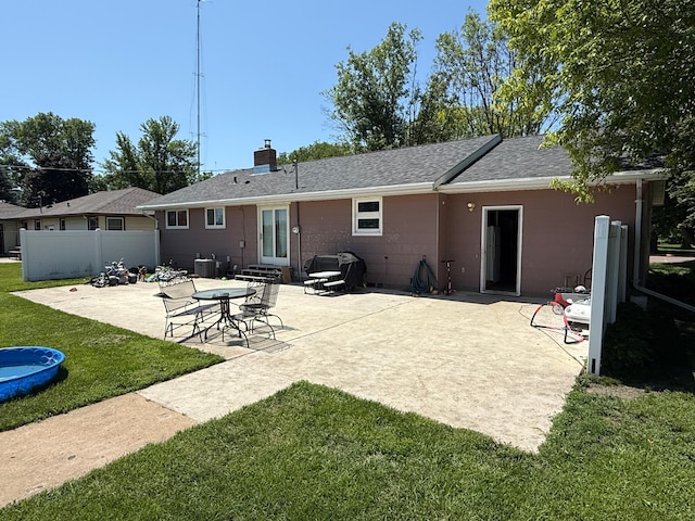 122 3rd St E, Morgan, MN 56266 - rear view of property with a patio area, entry steps, a chimney, and roof with shingles