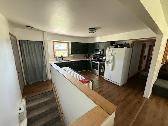 122 3rd St E, Morgan, MN 56266 - kitchen featuring white refrigerator with ice dispenser, black microwave, stainless steel range with electric stovetop, and dark wood-style floors