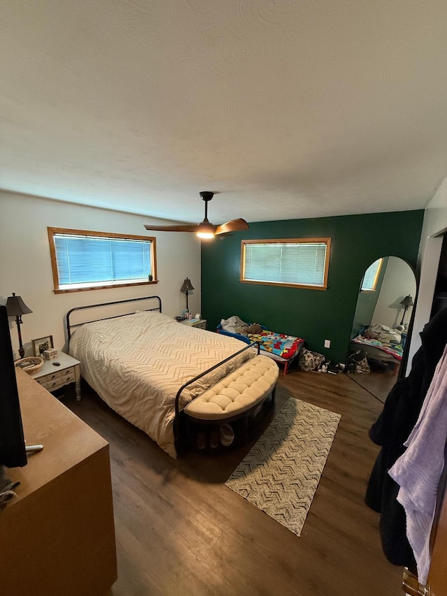 122 3rd St E, Morgan, MN 56266 - bedroom with wood finished floors, multiple windows, and ceiling fan