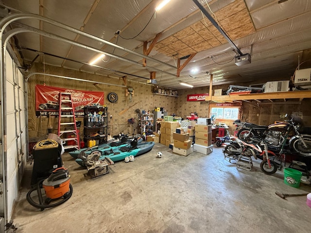 122 3rd St E, Morgan, MN 56266 - garage with a workshop area and a garage door opener