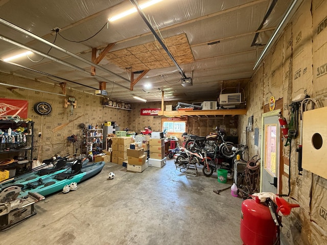 122 3rd St E, Morgan, MN 56266 - garage with a workshop area and a garage door opener