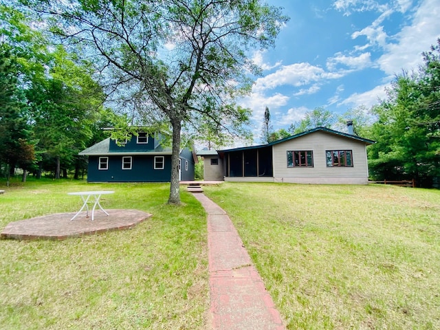 W7486 Burval Dr, Minong, WI 54859 - back of house featuring a sunroom and a lawn