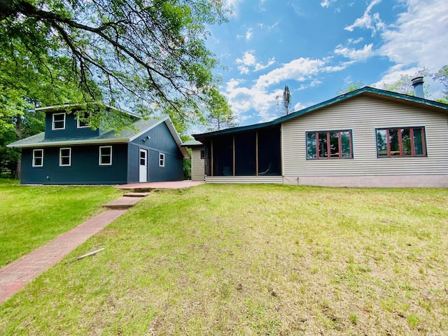 W7486 Burval Dr, Minong, WI 54859 - back of house with a sunroom, a lawn, and a patio