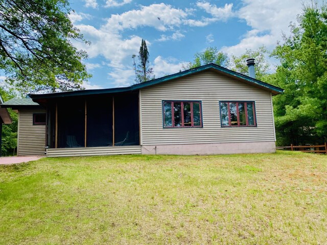 W7486 Burval Dr, Minong, WI 54859 - back of house with a lawn and a sunroom