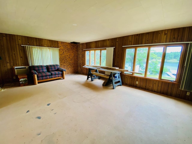 W7486 Burval Dr, Minong, WI 54859 - living room featuring wooden walls and concrete floors