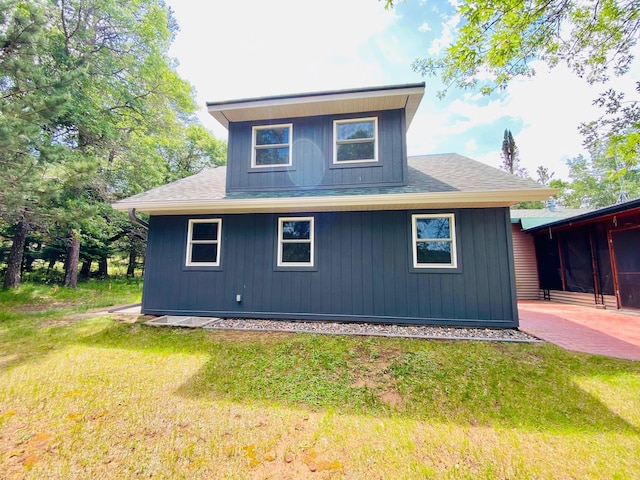 W7486 Burval Dr, Minong, WI 54859 - view of side of home featuring roof with shingles, a yard, and a patio area