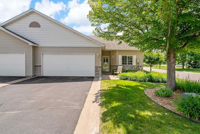 1112 Iris Dr, White Bear Twp, MN 55127 - view of front of home featuring stone siding, an attached garage, asphalt driveway, and a front yard
