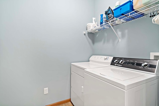 1112 Iris Dr, White Bear Twp, MN 55127 - laundry area featuring washer and clothes dryer and light wood-type flooring