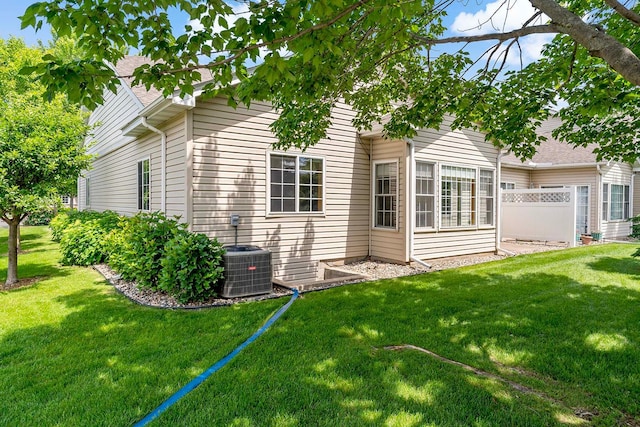 1112 Iris Dr, White Bear Twp, MN 55127 - rear view of house featuring a lawn and a shingled roof