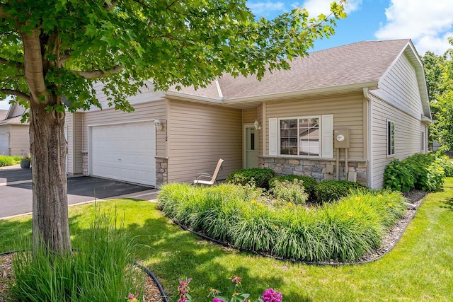 1112 Iris Dr, White Bear Twp, MN 55127 - view of front of property featuring stone siding, asphalt driveway, and a front yard